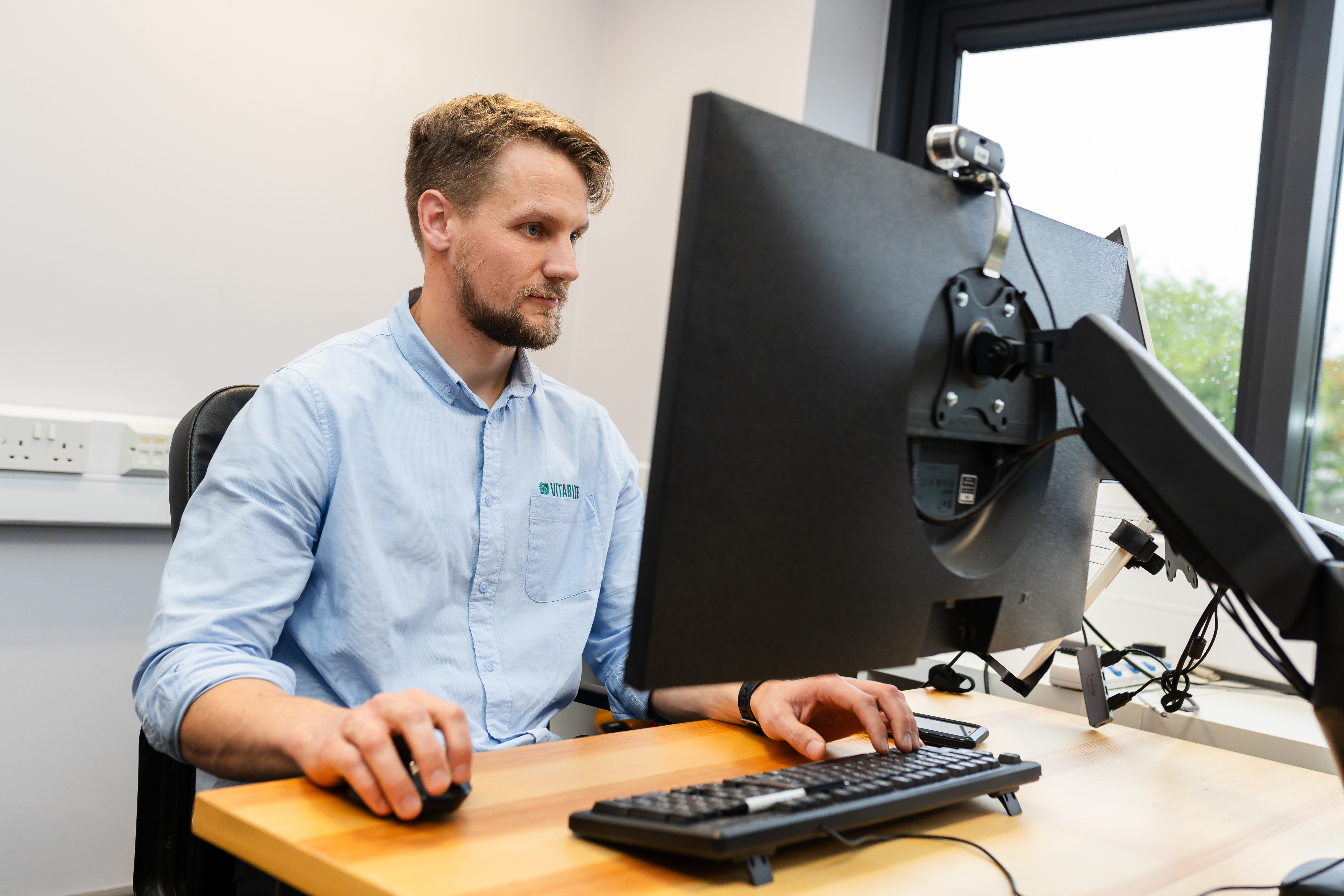 Vitabyte team member working with technical equipment